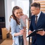 stock photo attractive woman holding arms daughter signing document handsome broker holding