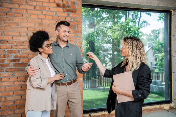 stock photo real estate broker documents giving keys new house pleased multicultural